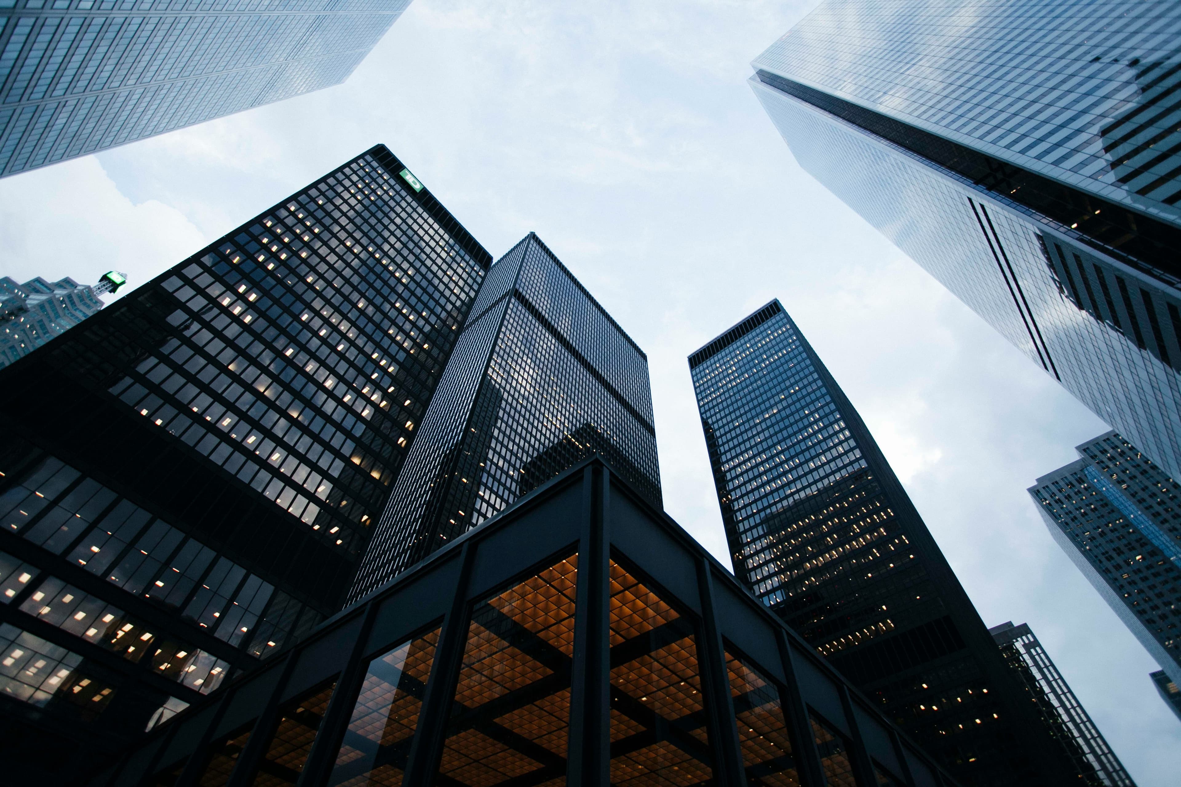 High-rise office towers viewed from below against an overcast sky